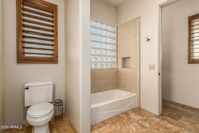 bathroom featuring toilet and shower / bath combination