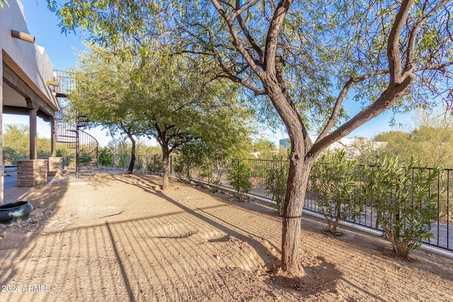 view of yard featuring fence and stairway