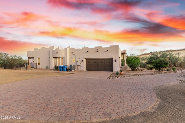 pueblo-style house with a garage