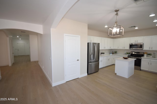 28377 N Desert Native St, San Tan Valley, AZ 85143 - kitchen featuring stainless steel appliances, arched walkways, light countertops, a chandelier, and white cabinetry