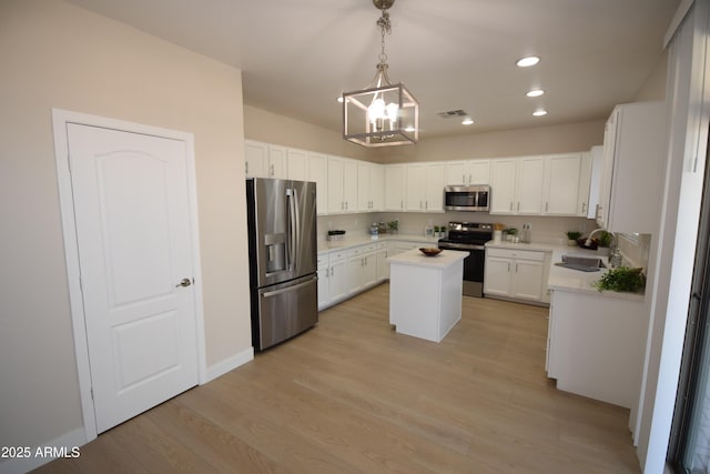 28377 N Desert Native St, San Tan Valley, AZ 85143 - kitchen featuring appliances with stainless steel finishes, a kitchen island, a chandelier, light countertops, and white cabinetry