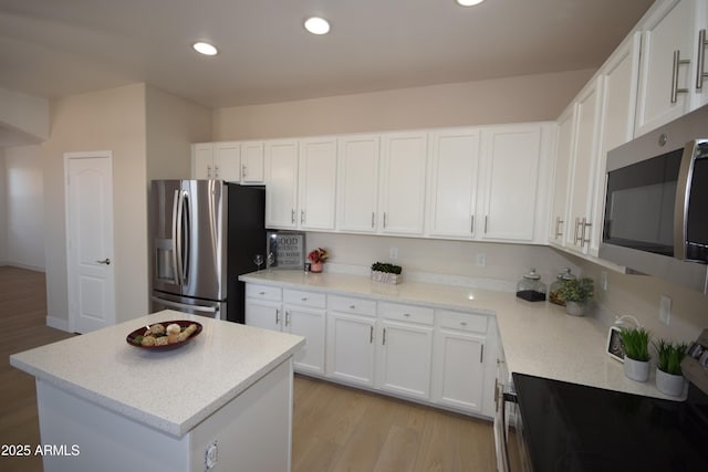 28377 N Desert Native St, San Tan Valley, AZ 85143 - kitchen with stainless steel appliances, white cabinets, light wood-style flooring, a center island, and recessed lighting