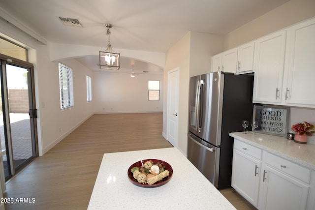 28377 N Desert Native St, San Tan Valley, AZ 85143 - kitchen featuring stainless steel refrigerator with ice dispenser, a chandelier, light wood-style floors, white cabinets, and light stone counters