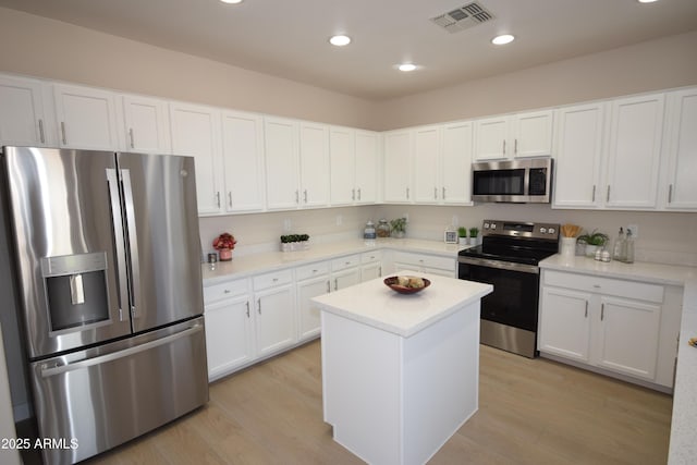 28377 N Desert Native St, San Tan Valley, AZ 85143 - kitchen featuring appliances with stainless steel finishes, light wood-type flooring, light countertops, white cabinets, and recessed lighting