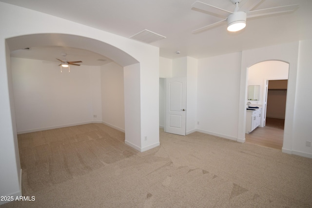 28377 N Desert Native St, San Tan Valley, AZ 85143 - empty room featuring ceiling fan, arched walkways, and light carpet