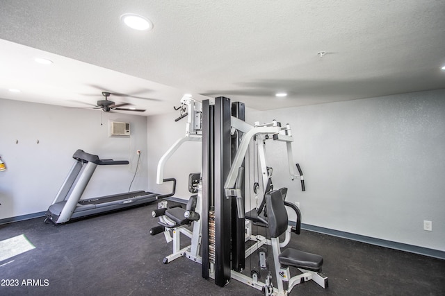 exercise room with baseboards, a textured ceiling, and recessed lighting