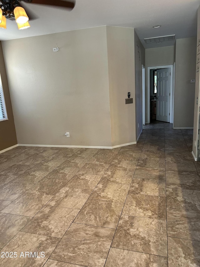 spare room with baseboards and visible vents