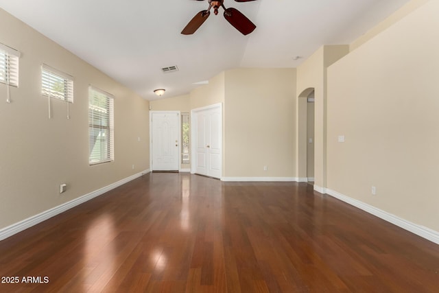 unfurnished room with vaulted ceiling, ceiling fan, and dark hardwood / wood-style floors