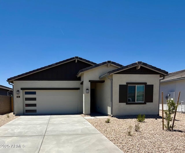 658 S Maricopa Rd, Florence, AZ 85132 - view of front of home featuring concrete driveway, an attached garage, and stucco siding