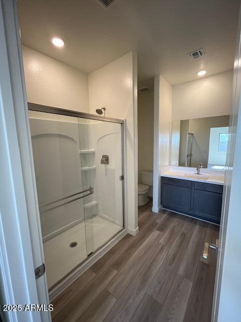 658 S Maricopa Rd, Florence, AZ 85132 - bathroom with toilet, wood finished floors, a shower stall, vanity, and recessed lighting