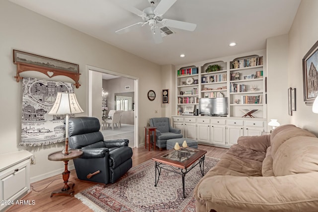 living room with light hardwood / wood-style floors and ceiling fan