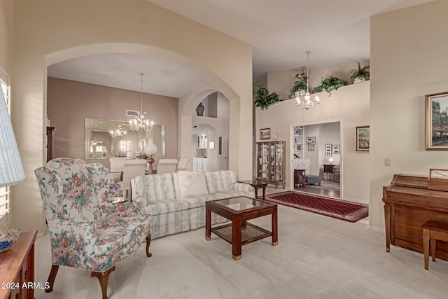 carpeted living room featuring a chandelier