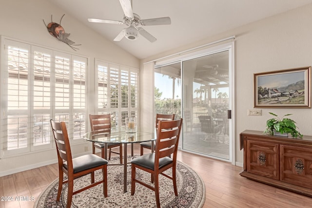 dining area featuring hardwood / wood-style floors, ceiling fan, and vaulted ceiling