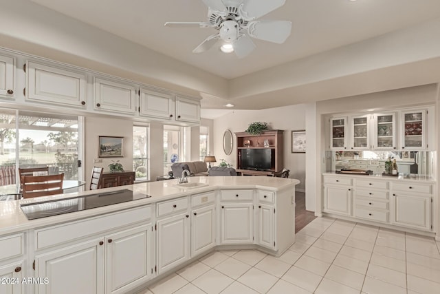 kitchen featuring black electric stovetop and white cabinets