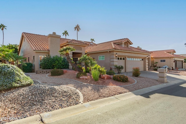 mediterranean / spanish house with a garage