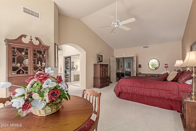 bedroom with light carpet, high vaulted ceiling, ceiling fan, connected bathroom, and a closet