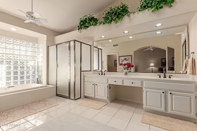 bathroom with tile patterned flooring, vanity, and plus walk in shower