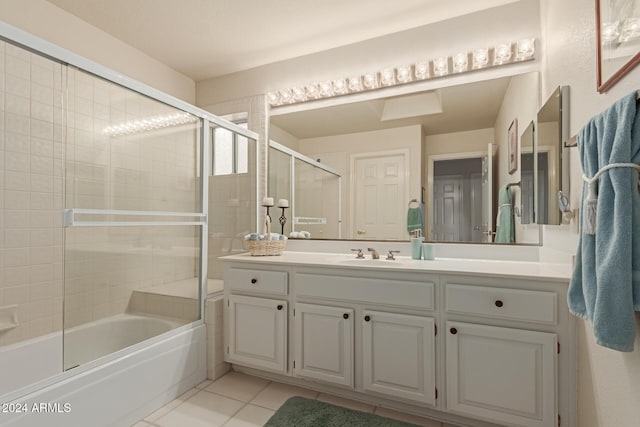 bathroom with tile patterned flooring, vanity, and combined bath / shower with glass door