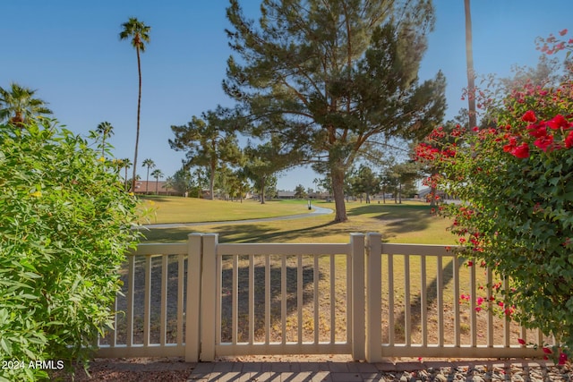 view of gate featuring a yard