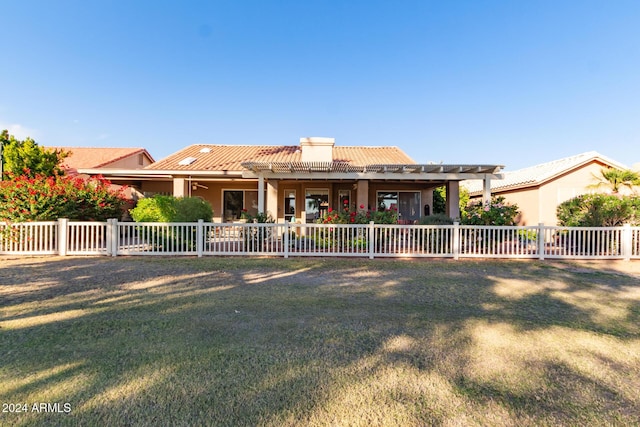 view of front of house with a front yard and a pergola