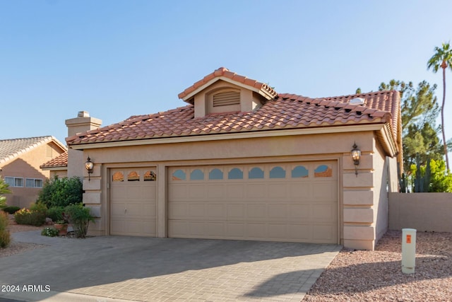 mediterranean / spanish home featuring a garage