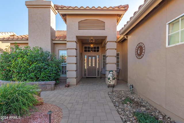 view of exterior entry featuring a patio area