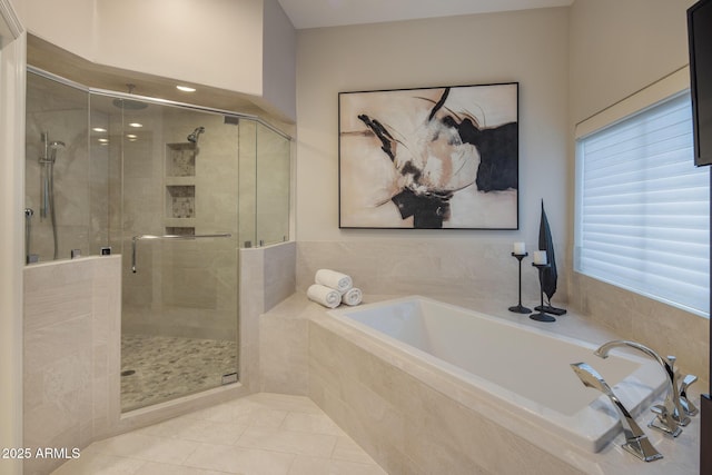 bathroom featuring plus walk in shower and tile patterned floors