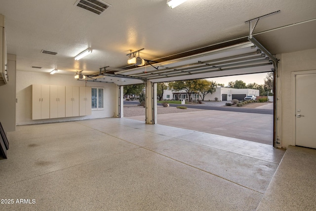 garage at dusk featuring a garage door opener