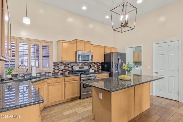 240 W Brooks St, Gilbert, AZ 85233 - kitchen with tasteful backsplash, a high ceiling, a sink, stainless steel appliances, and washer / dryer