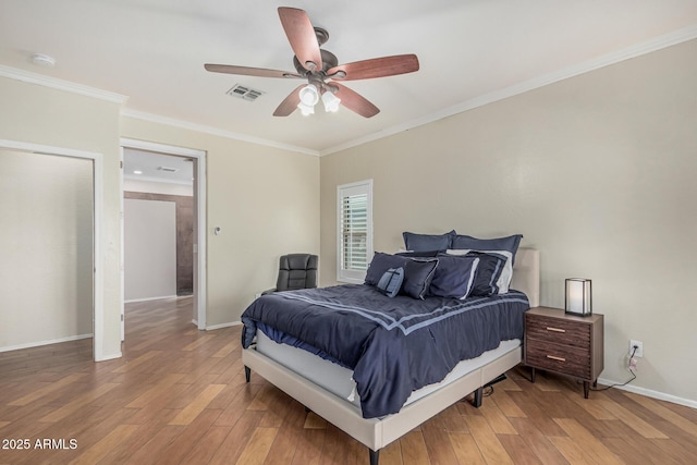 240 W Brooks St, Gilbert, AZ 85233 - bedroom featuring crown molding, a ceiling fan, visible vents, wood finished floors, and baseboards