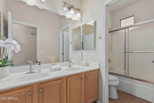 240 W Brooks St, Gilbert, AZ 85233 - full bathroom featuring a sink, toilet, double vanity, and wood finished floors