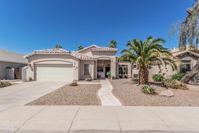 240 W Brooks St, Gilbert, AZ 85233 - mediterranean / spanish-style home with an attached garage, driveway, stucco siding, and a tile roof