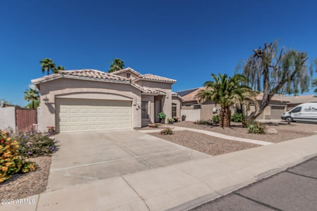 240 W Brooks St, Gilbert, AZ 85233 - mediterranean / spanish home featuring stucco siding, driveway, an attached garage, a tiled roof, and fence