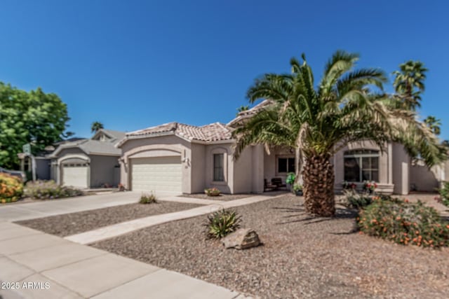240 W Brooks St, Gilbert, AZ 85233 - mediterranean / spanish-style house with a garage, stucco siding, concrete driveway, and a tile roof