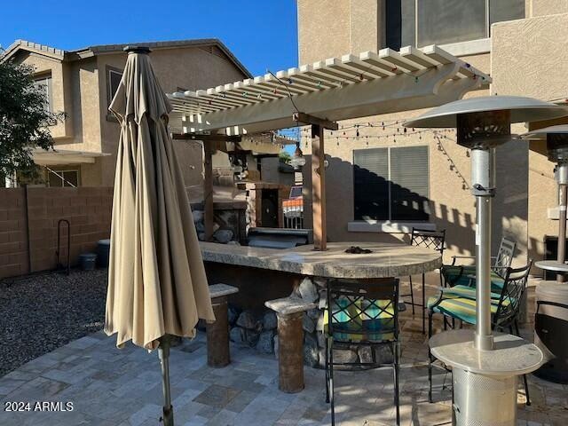 view of patio / terrace featuring a pergola and a bar