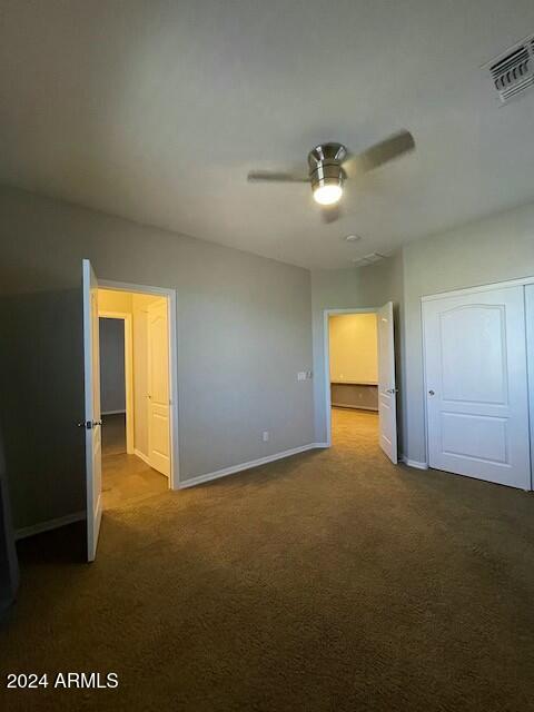 unfurnished bedroom featuring carpet flooring and ceiling fan