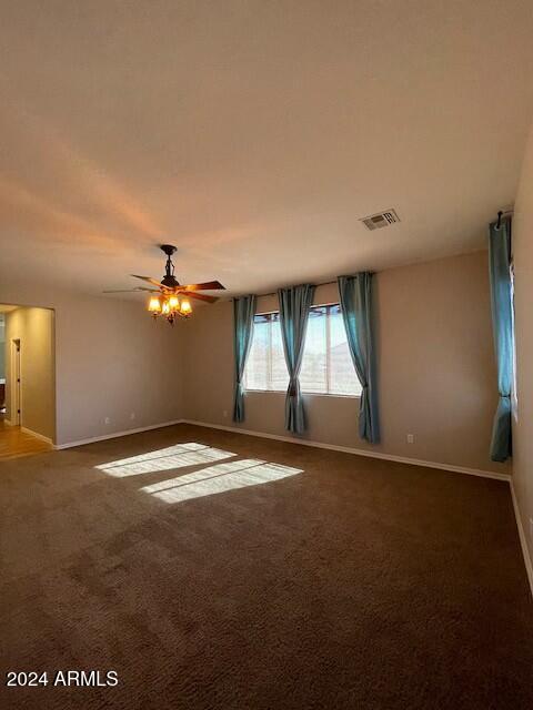 carpeted empty room featuring ceiling fan