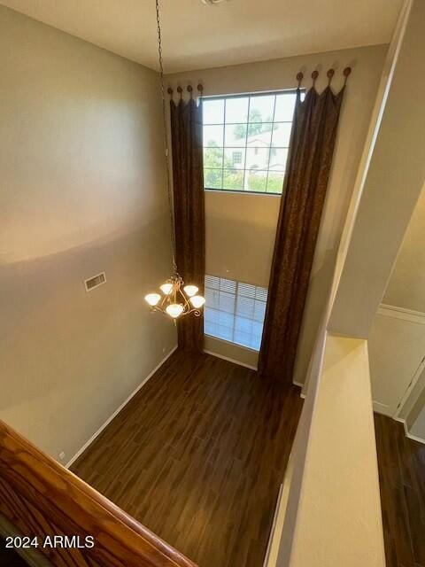 interior space featuring hardwood / wood-style flooring and a chandelier