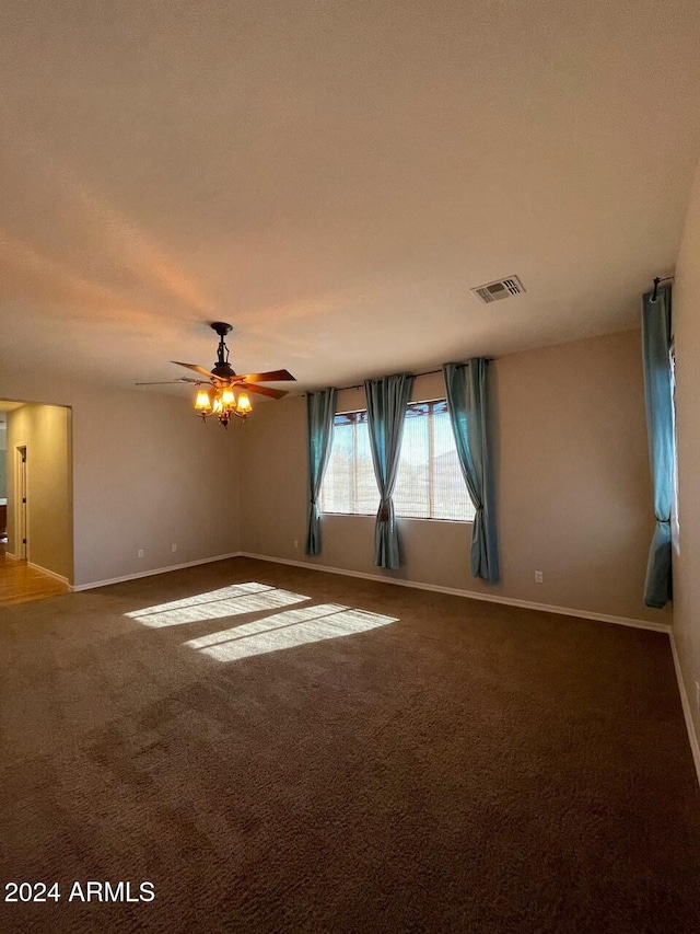 empty room with ceiling fan and carpet floors