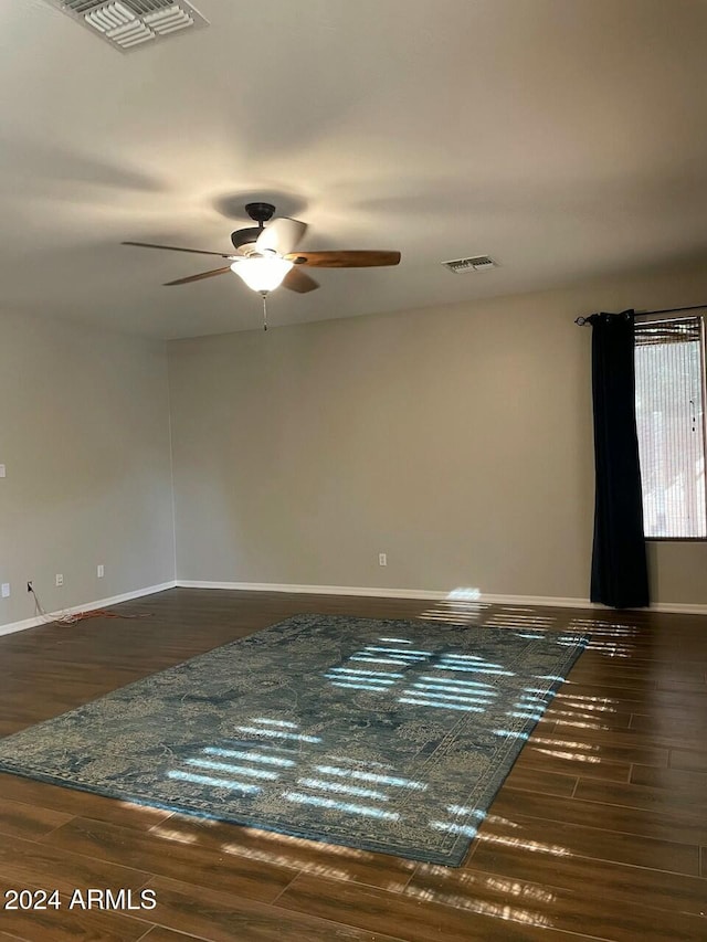 unfurnished room with ceiling fan and dark hardwood / wood-style floors