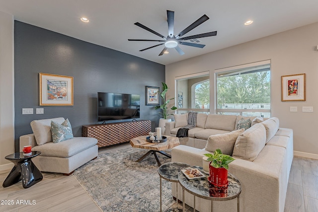 living room featuring light hardwood / wood-style floors and ceiling fan