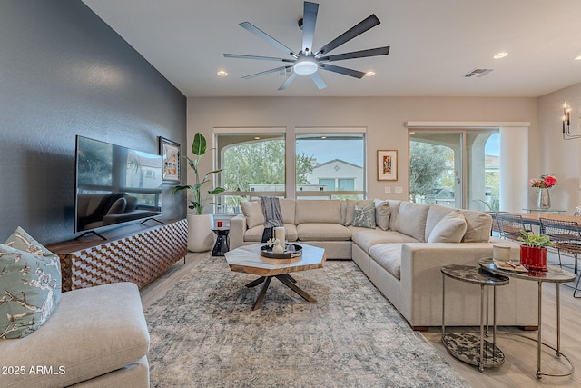 living room featuring ceiling fan and hardwood / wood-style floors