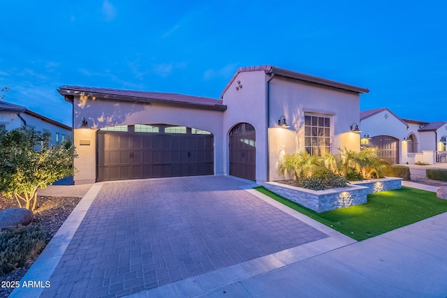 mediterranean / spanish house with a garage