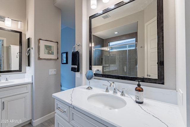 bathroom with an enclosed shower and vanity