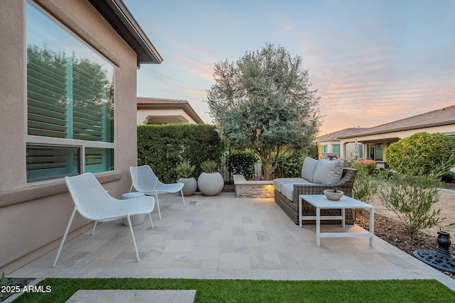 patio terrace at dusk featuring an outdoor hangout area