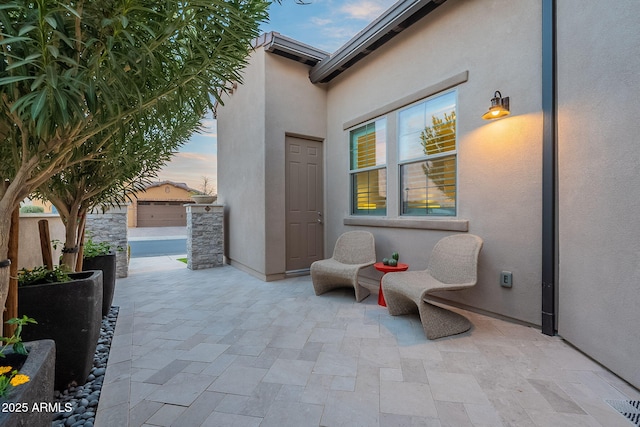 view of patio terrace at dusk