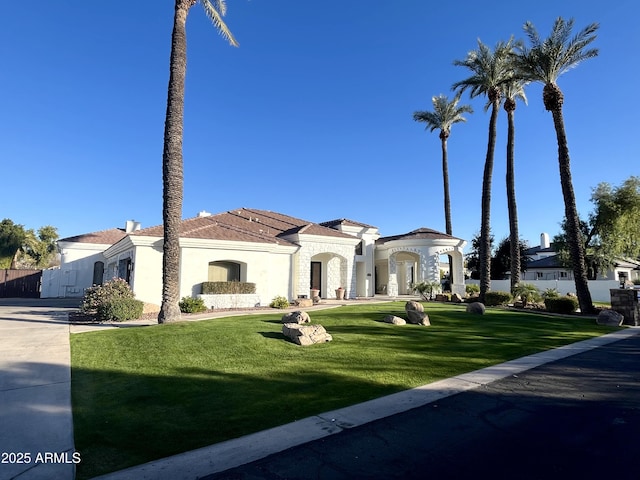 mediterranean / spanish-style house featuring a front lawn