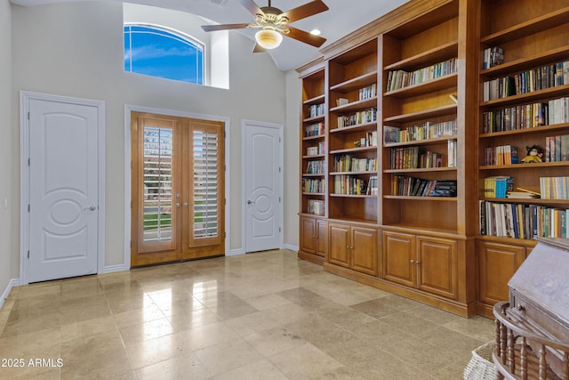 entrance foyer featuring a high ceiling, ceiling fan, and french doors