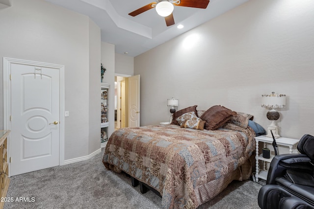 bedroom featuring a tray ceiling, ceiling fan, and carpet