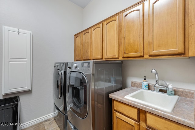 washroom featuring cabinets, sink, and independent washer and dryer